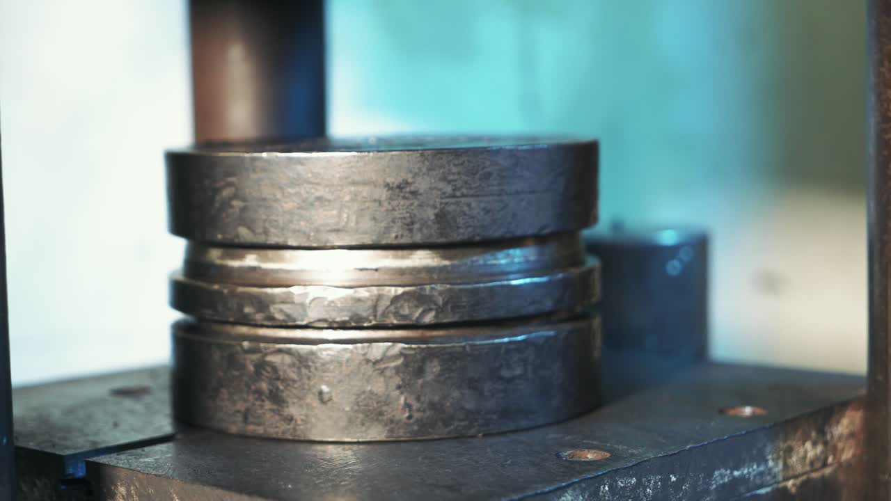 Work on the hydraulic press. Metal production heavy machines at factory