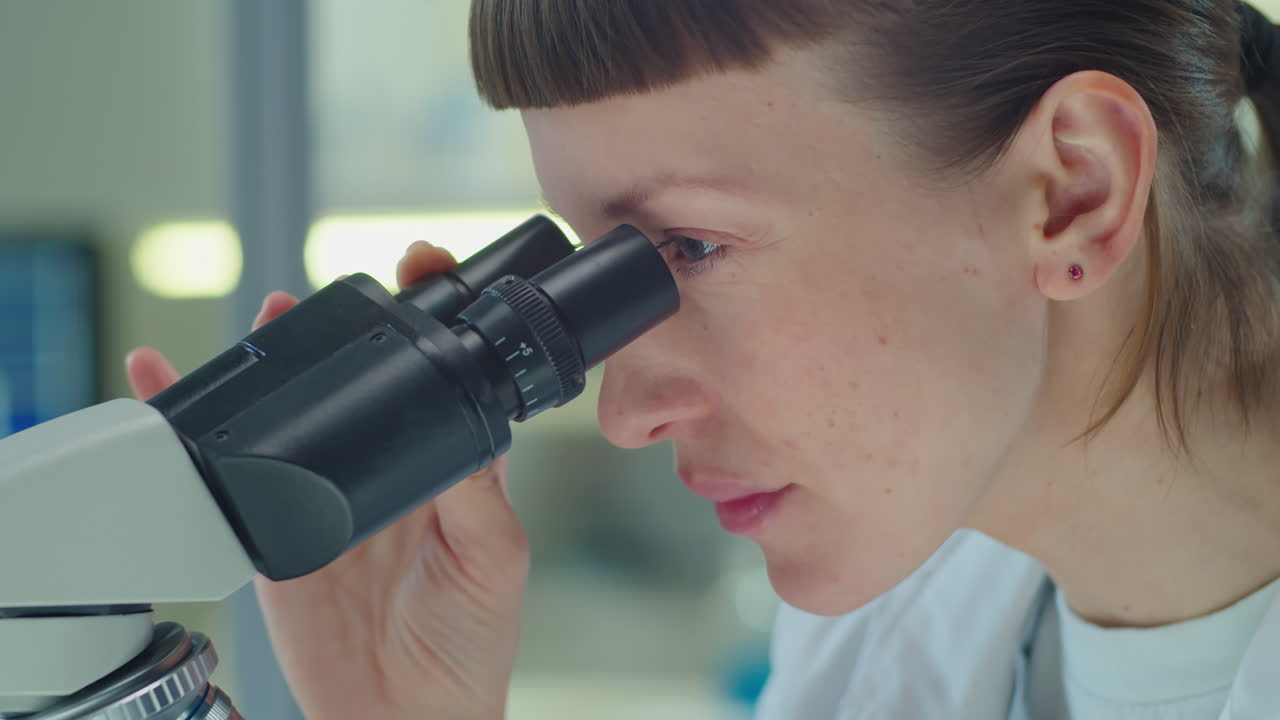 Female Scientist Doing Lab Research with Microscope