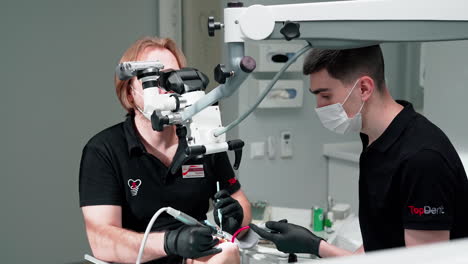 doctor using microscope at dental clinic. dentist using dental microscope in the dentist office