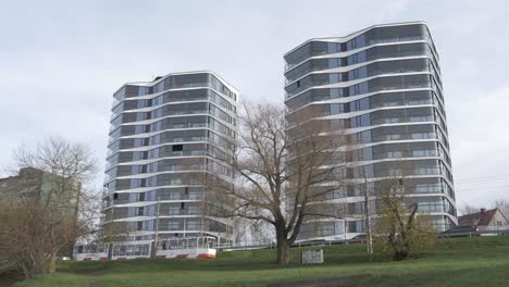 the tram passes by multi-storey buildings 4k