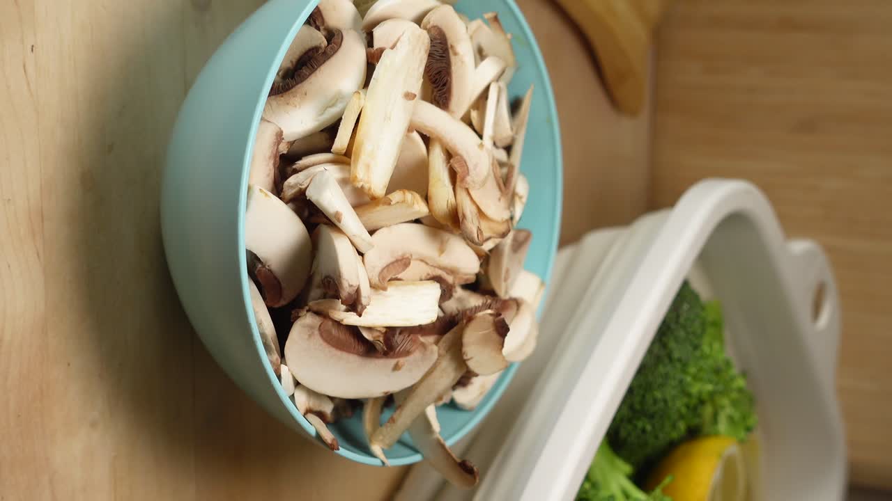 Sliced Mushrooms in a Blue Bowl with Vegetables