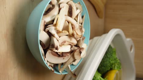 sliced mushrooms in a blue bowl with vegetables