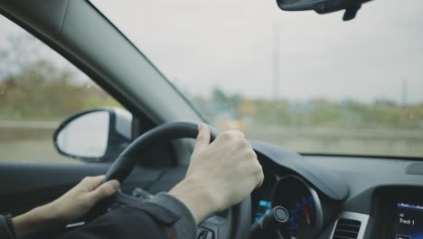 Male-Driver-Hands-On-Steering-Wheel-Driving-A-Car---Closeup-Shot,-Handheld