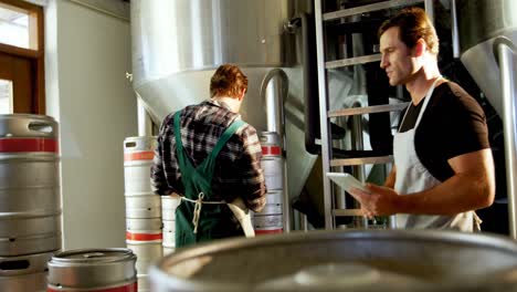 two brewers maintaining record on digital tablet 4k