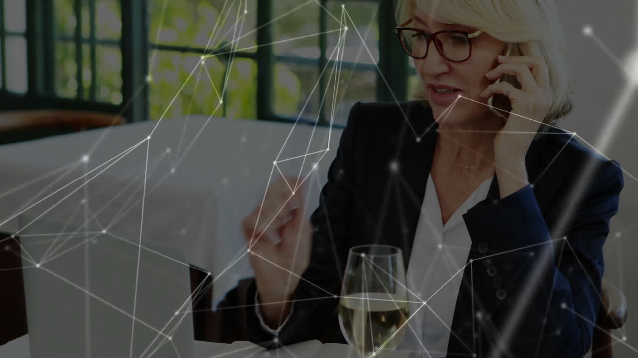 businesswoman making phone call in modern office, showing digital network graphics overlay