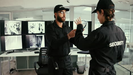 two security guards in a security office