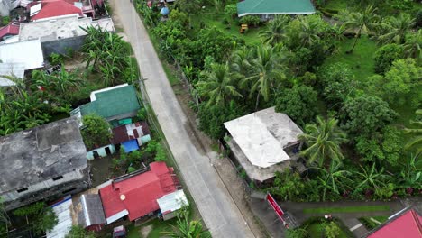 aerial tilt down dolly, tropical southeast asia neighborhood or village on sunny day