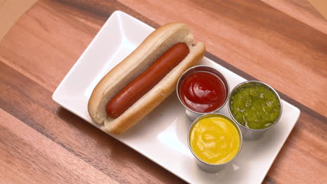 hand taking hot dogs off a plate