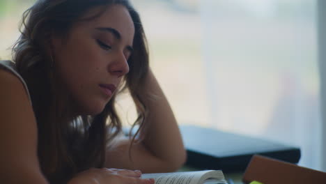 tired female student studying for exams