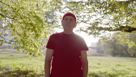 senior old man running in park and using smart watch, tracking result after fitness workout