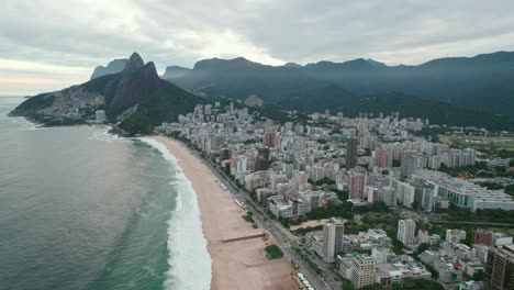 aerial panoramic view of leblon beach ipanema rio de janeiro brazil neighborhood residential area, green mountains and skyline, rich zone drone establishing shot