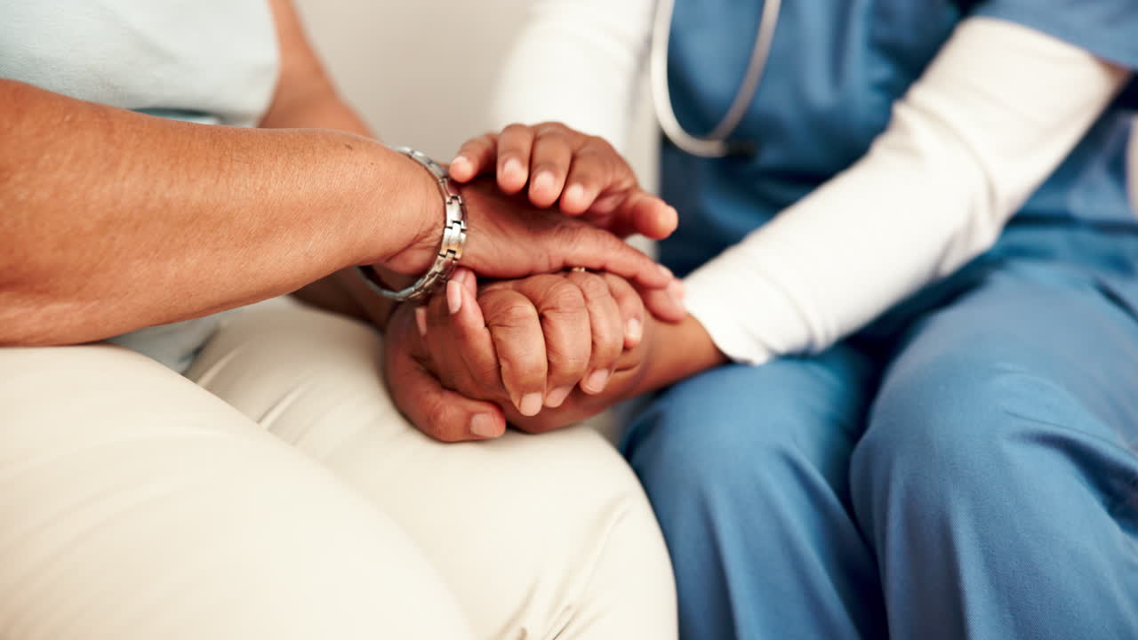 A nurse supporting a patient with a comforting touch