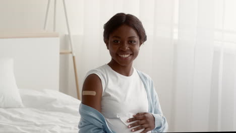 pregnant woman with vaccination band-aid