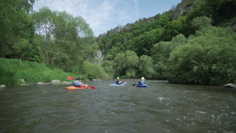 happy kayaker lifting hands up with paddle and enjoying river kayaking
