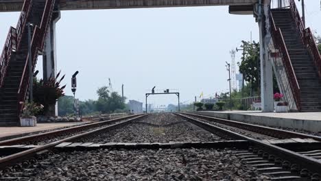 train moves towards camera on railroad tracks