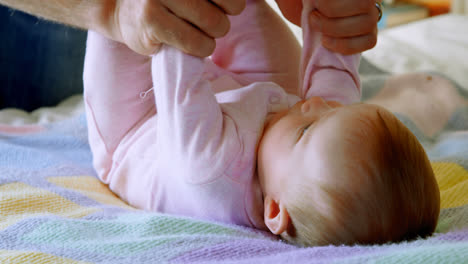 Close-up-of-of-caucasian-father-playing-with-baby-on-bed-in-a-comfortable-home-4k