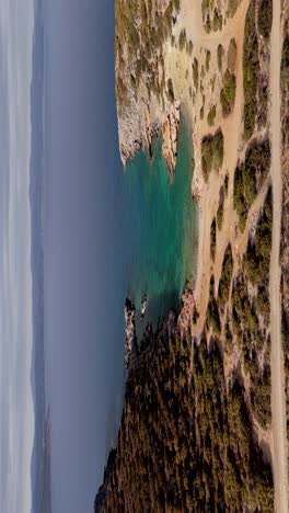 aerial - wild natural deserted beach with turquoise waters, crete island, greece - vertical