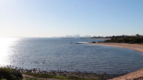 calm beach with city skyline backdrop