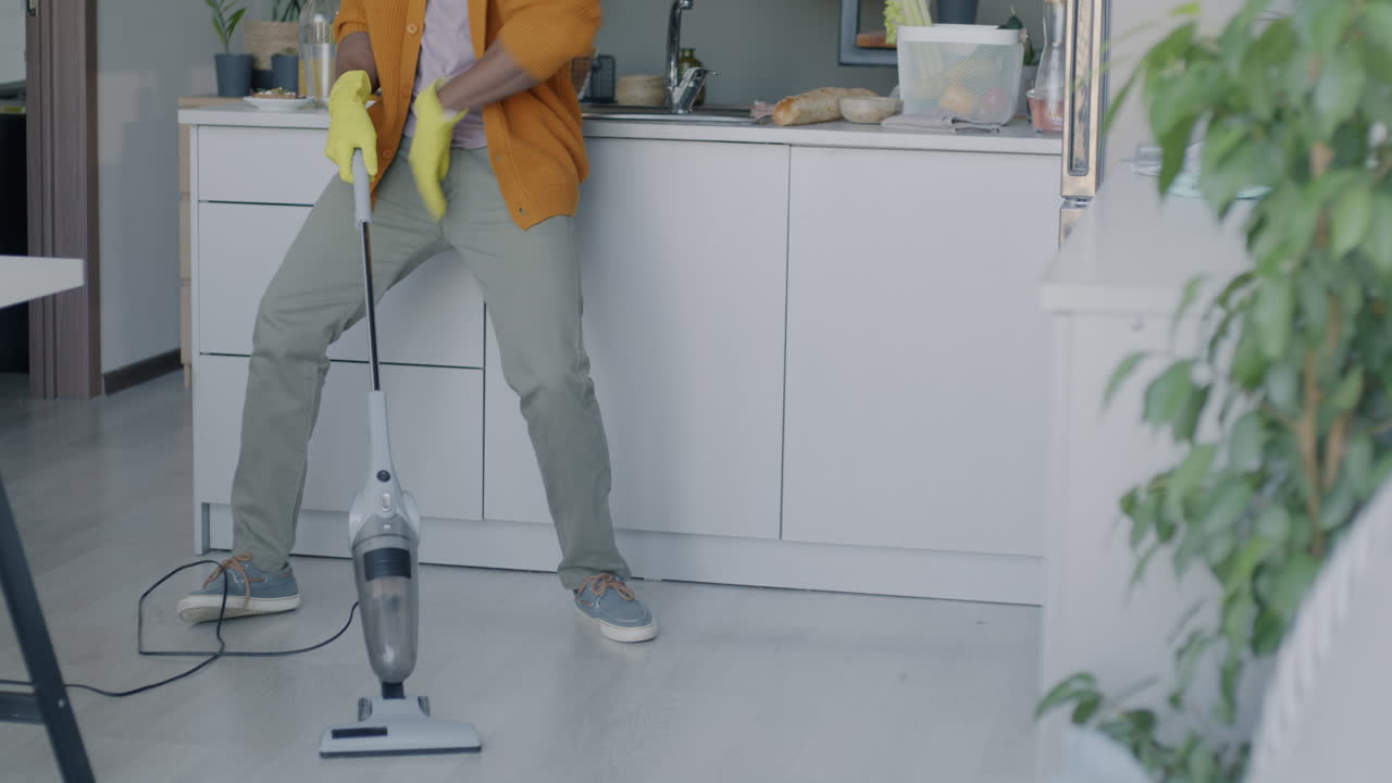 Man Cleaning and Dancing in Kitchen