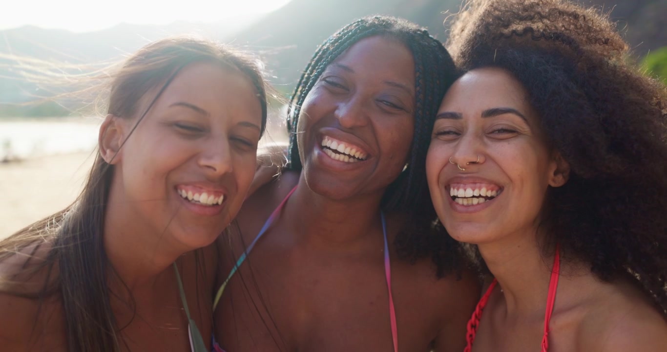 Joyful Multi-Ethnic Friends Smiling and Laughing on a Sunny Beach