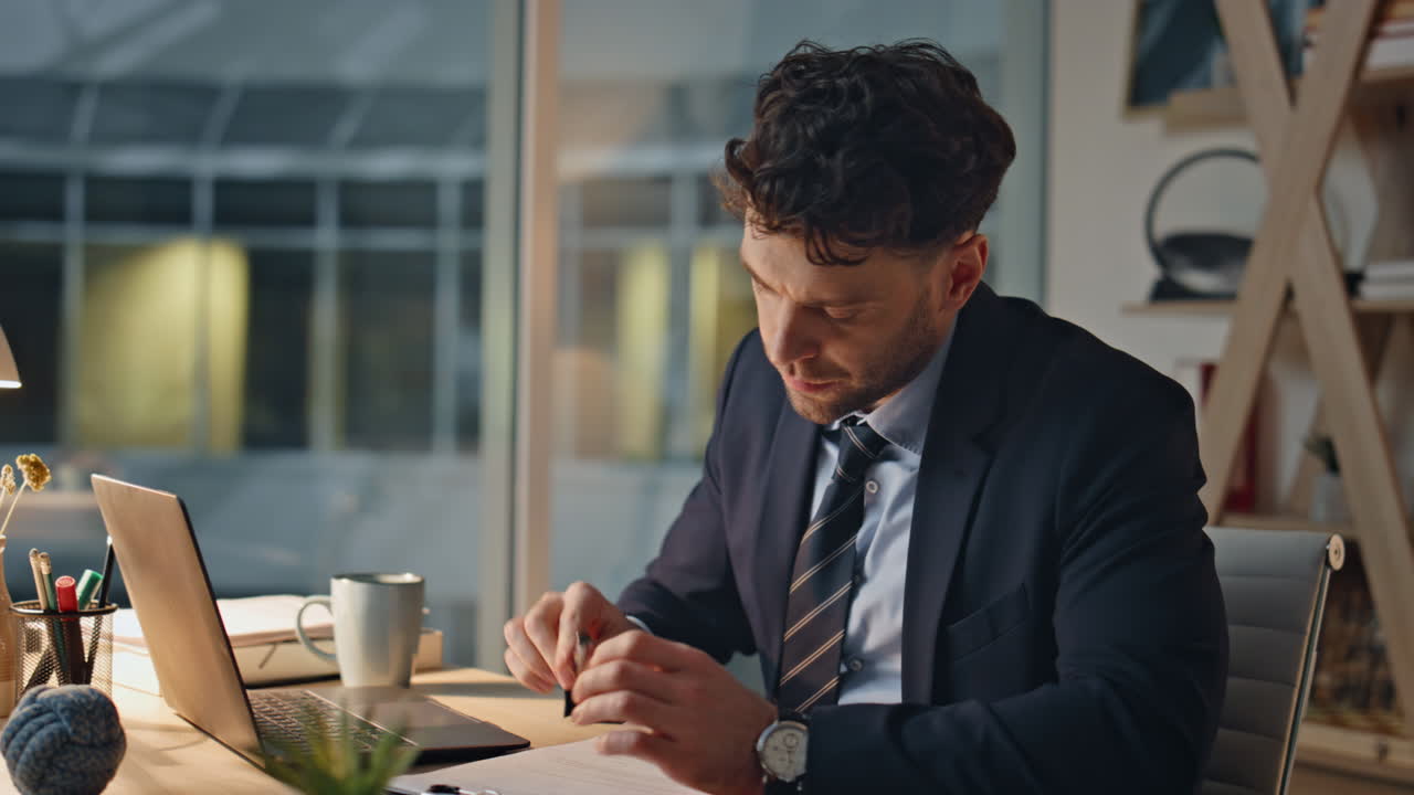 Company worker focused paperwork at office desk looking contemplative closeup