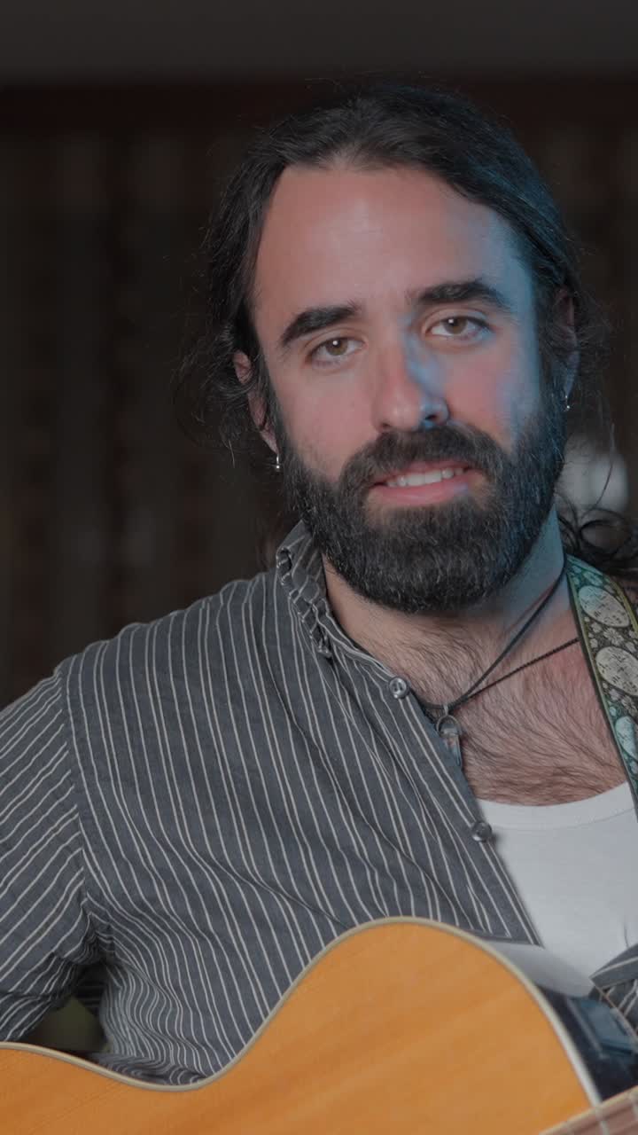 A man playing an acoustic guitar