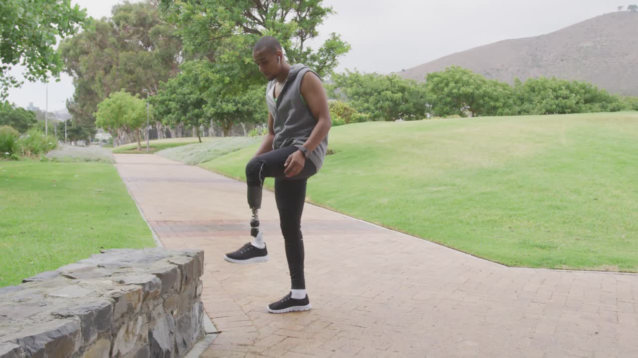 Side view man with prosthetic leg stretching