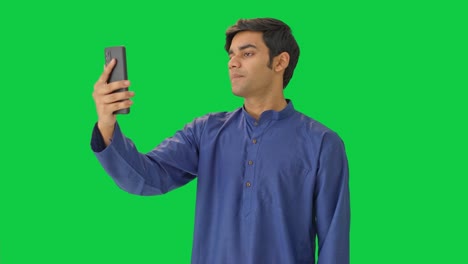 indian man talking on video call green screen