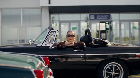 stylish woman in a vintage convertible