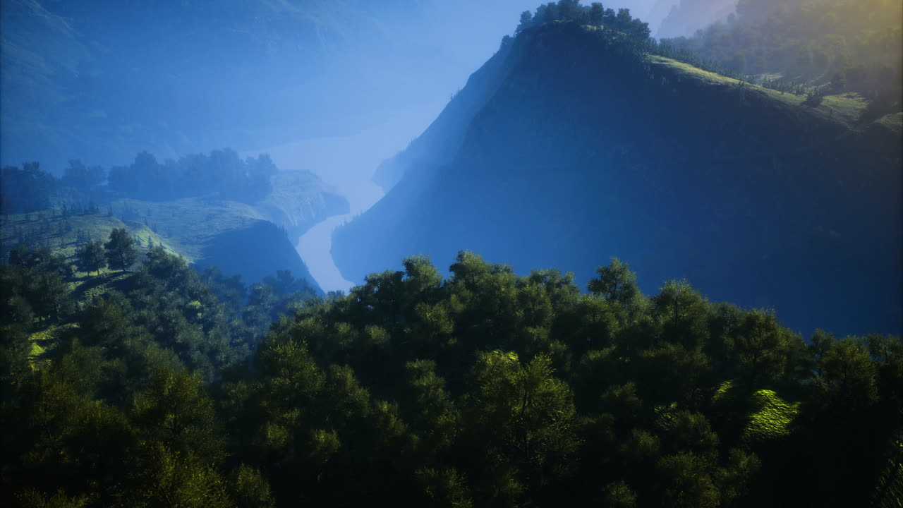 Morning light on majestic mountains and a river through lush valleys