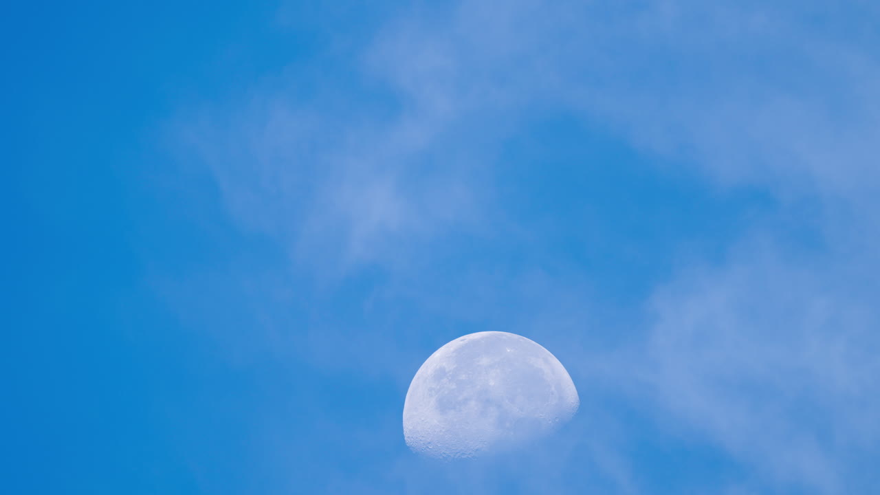 Moon Rising in Blue Sky with Clouds Timelapse