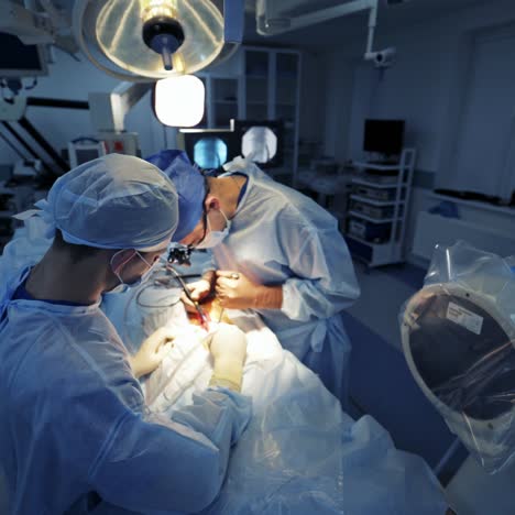 surgical procedure in the hospital. surgeon and male assistant perform an operation in the modern operating room. top view.