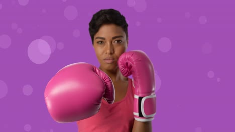 Animation-of-mixed-race-woman-wearing-boxing-gloves-on-purple-background