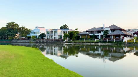 houses reflected in a tranquil lakeside setting