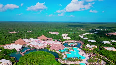 TRS-Yucatan-Resort-in-Tulum-Mexico-aerial-view-flying-away-from-the-hotel-with-pools-and-the-tropical-forest