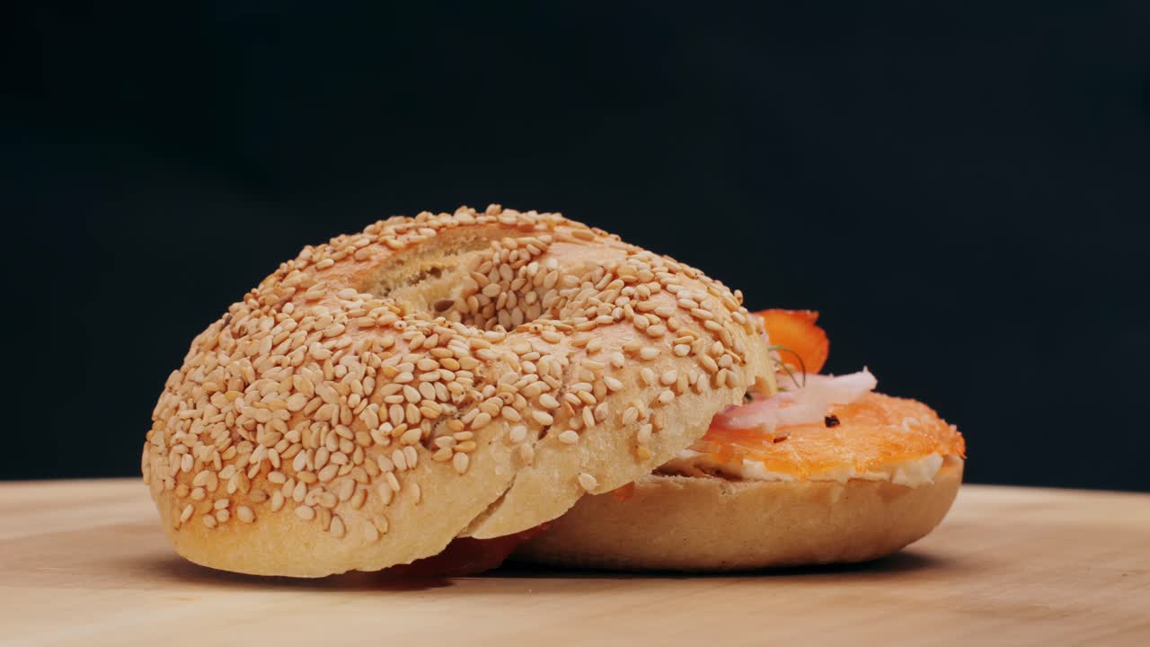 Bagel sandwich brunch, lunch plate of a bagel with smoked salmon and cream cheese and ham, close up morning cafe menu.