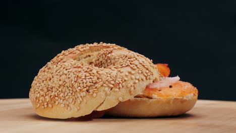 bagel sandwich brunch, lunch plate of a bagel with smoked salmon and cream cheese and ham, close up morning cafe menu.
