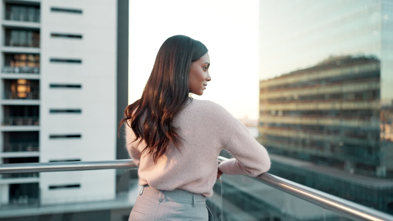 Woman on Balcony Overlooking Cityscape