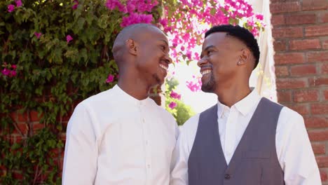 portrait of happy african american gay male couple at wedding, slow motion