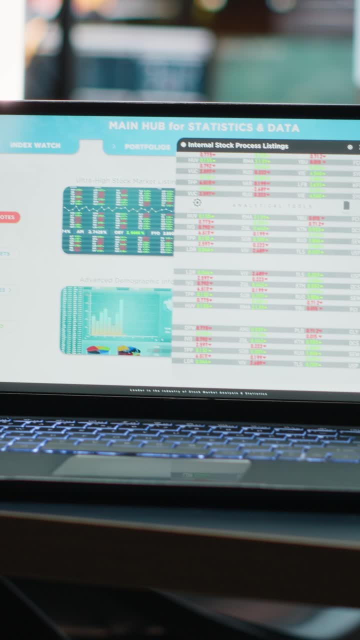 Vertical Video Laptop in a dark office multinational company with business analytics