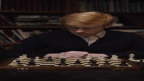 man playing chess in a library