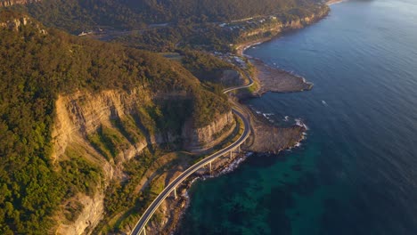 Majestic-Mountains-And-Cliffs-In-New-South-Wales-And-The-Sea-Cliff-Bridge-In-Australia---aerial-shot