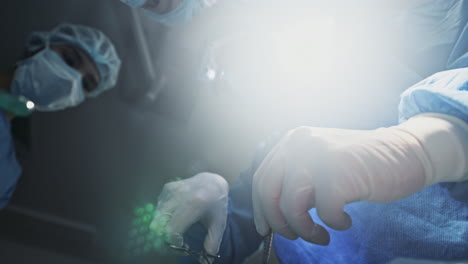 surgery, hospital light and doctors with scalpel