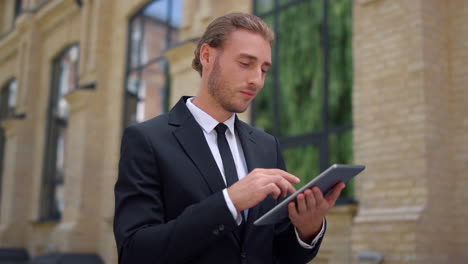 boss using digital tablet while walking to work