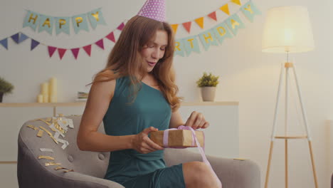 woman opening a birthday gift