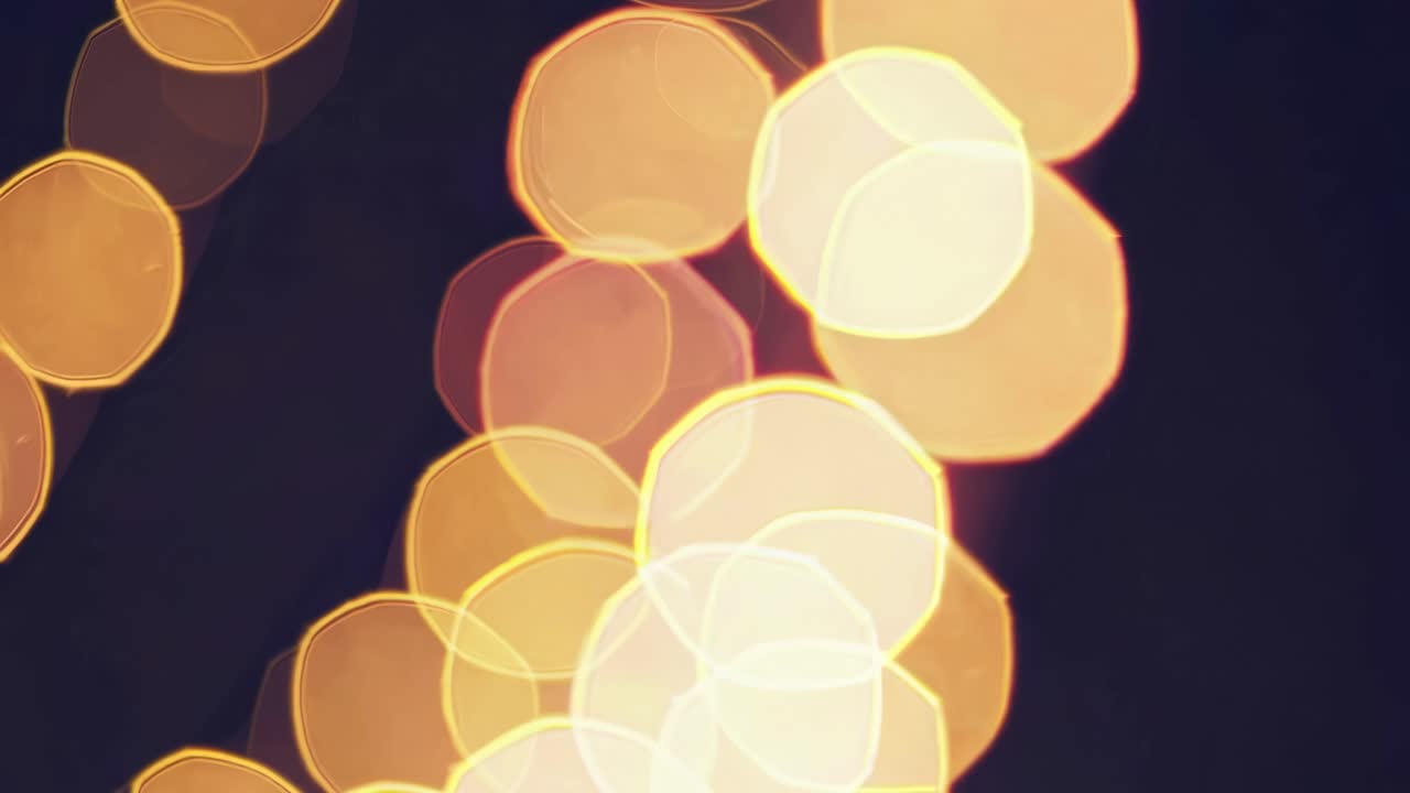 Abstract video with a bokeh effect, showcasing soft, glowing circles of light against a dark