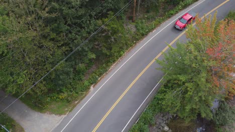 Pan-over-road-as-a-red-pick-up-truck-drives-by