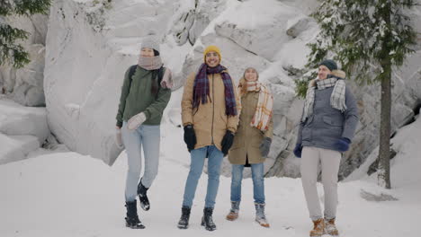 friends jumping and laughing in snowy mountains