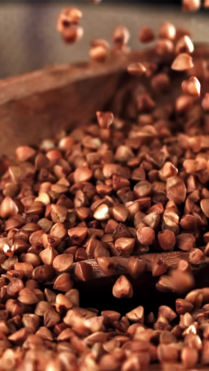 Slow Motion of Buckwheat Grains Pouring into a Wooden Spoon