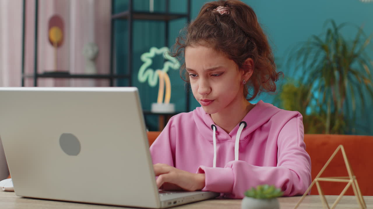 Preteen school girl using laptop for online lesson doing homework distance learning education